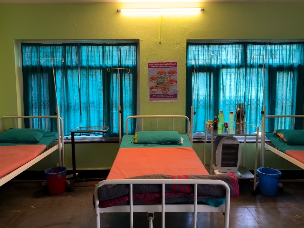 Clean patient recovery ward with clinical beds and fresh linens